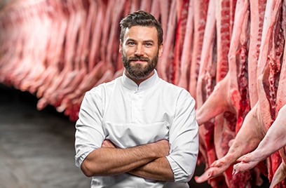 A butcher standing in a cold storage room
